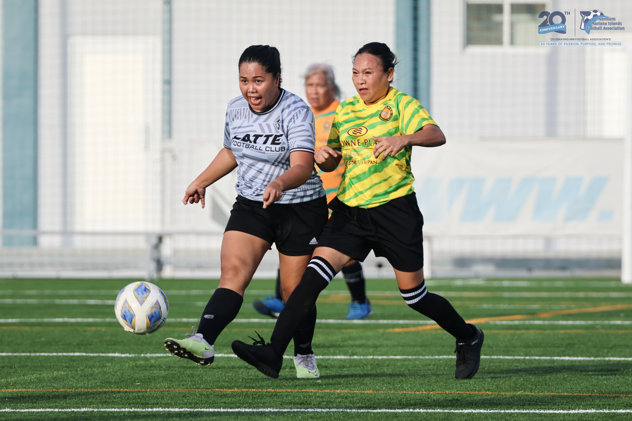 May be an image of 2 people, people playing football, people playing soccer, grass and text