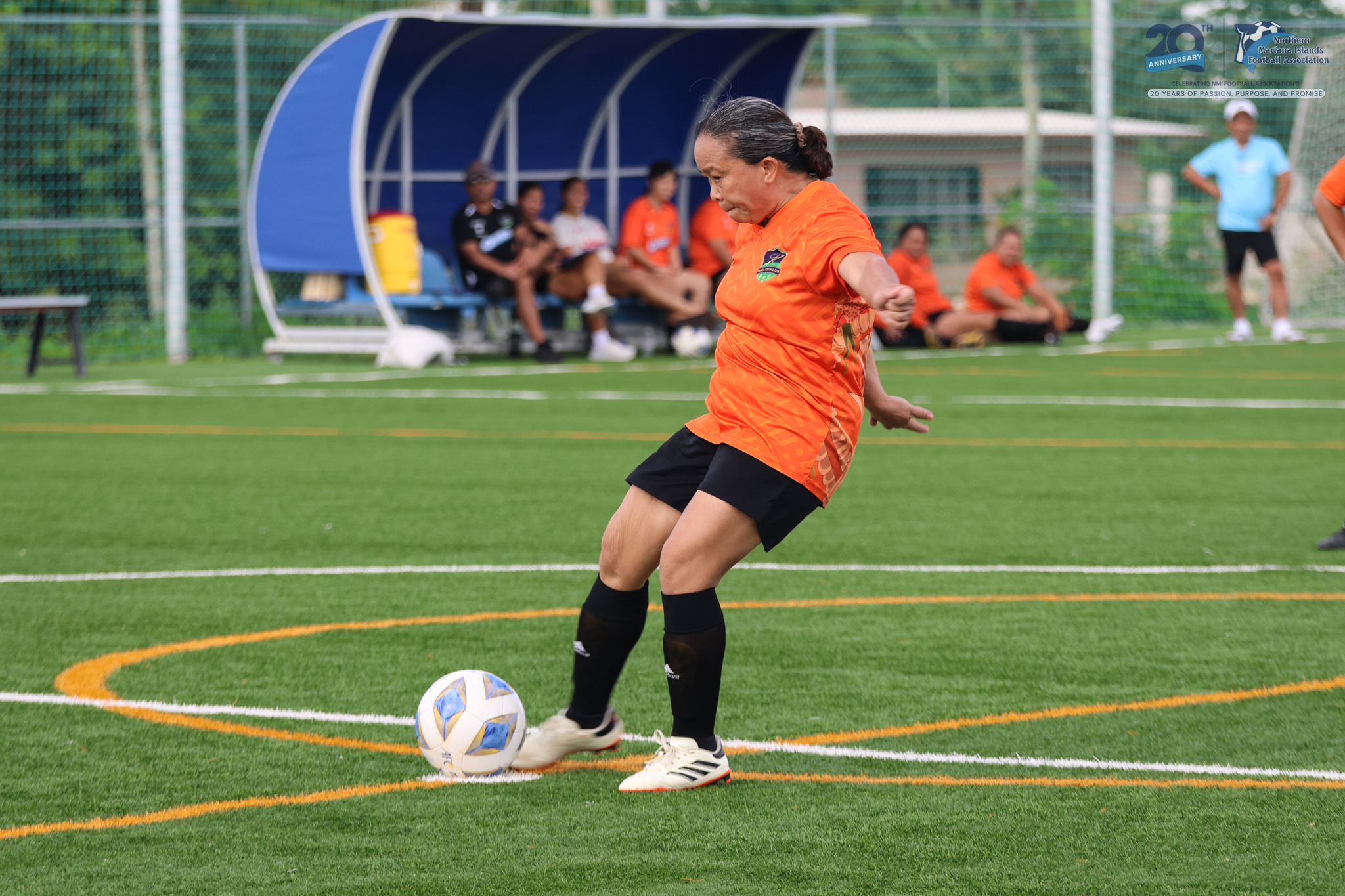 May be an image of 4 people, people playing football, people playing soccer, grass and text