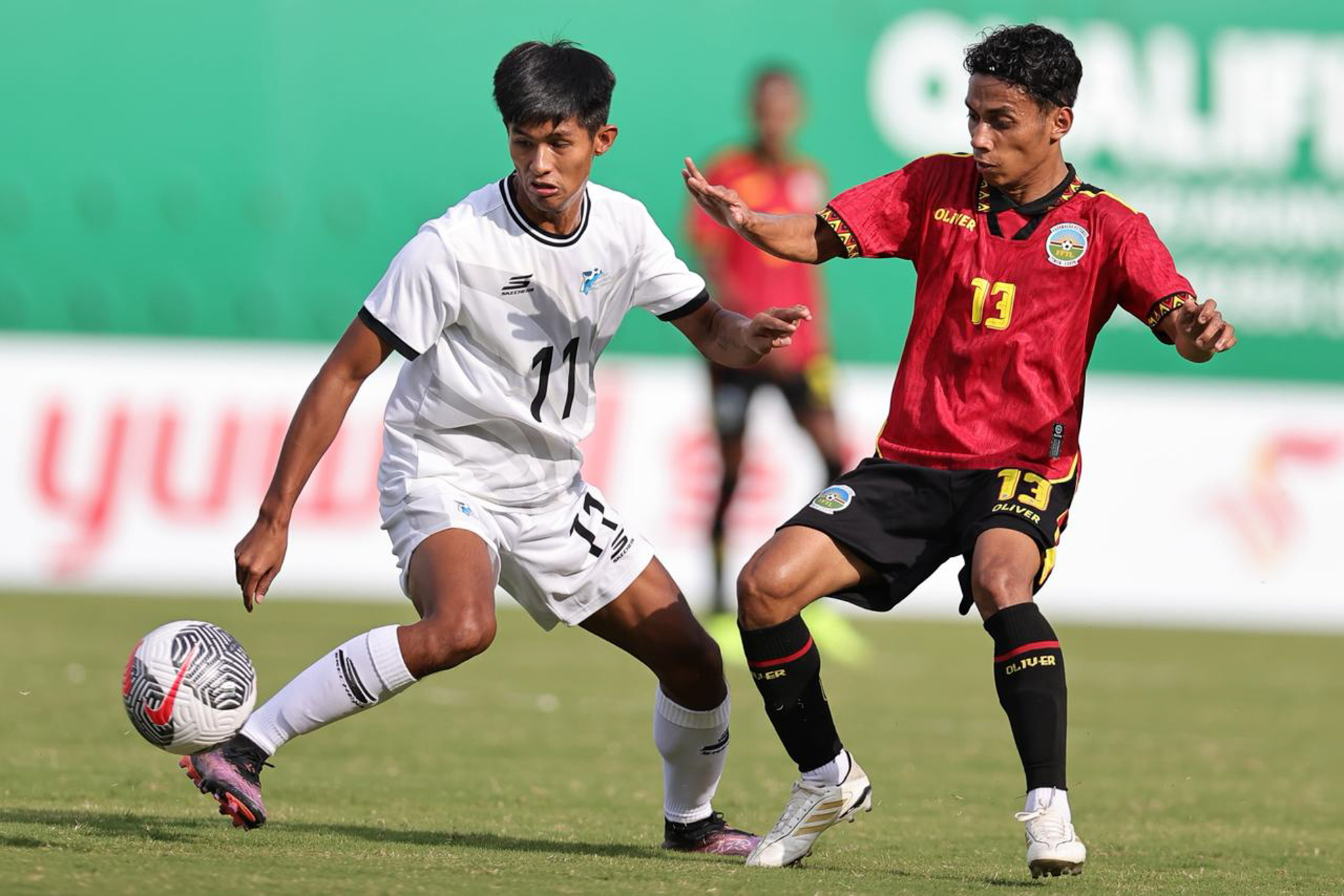 May be an image of 2 people, people playing football, people playing soccer and text