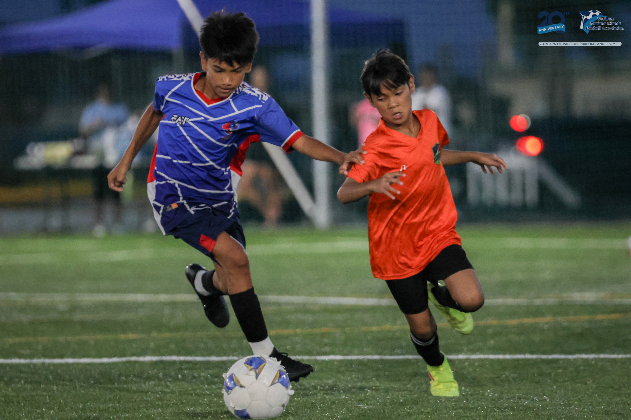 May be an image of 2 people, people playing football, people playing soccer and text