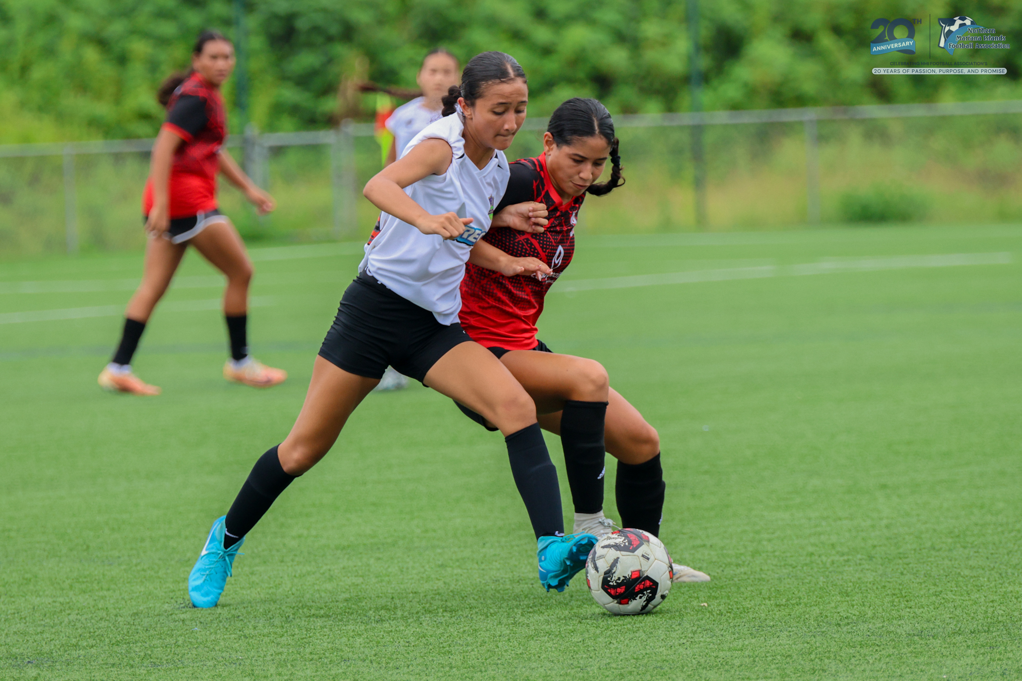 May be an image of 2 people, people playing football, people playing soccer, grass and text