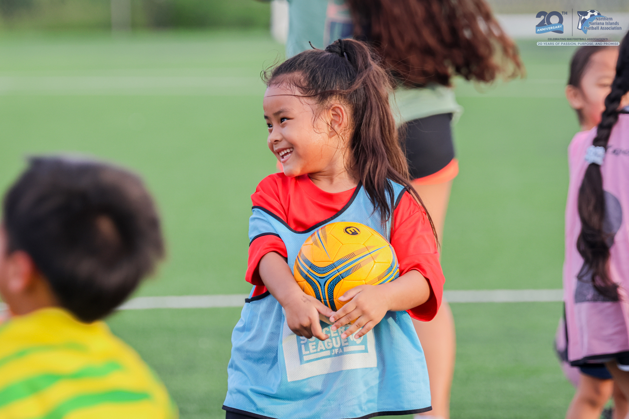May be an image of 4 people, child, people playing football, people playing soccer, grass and text