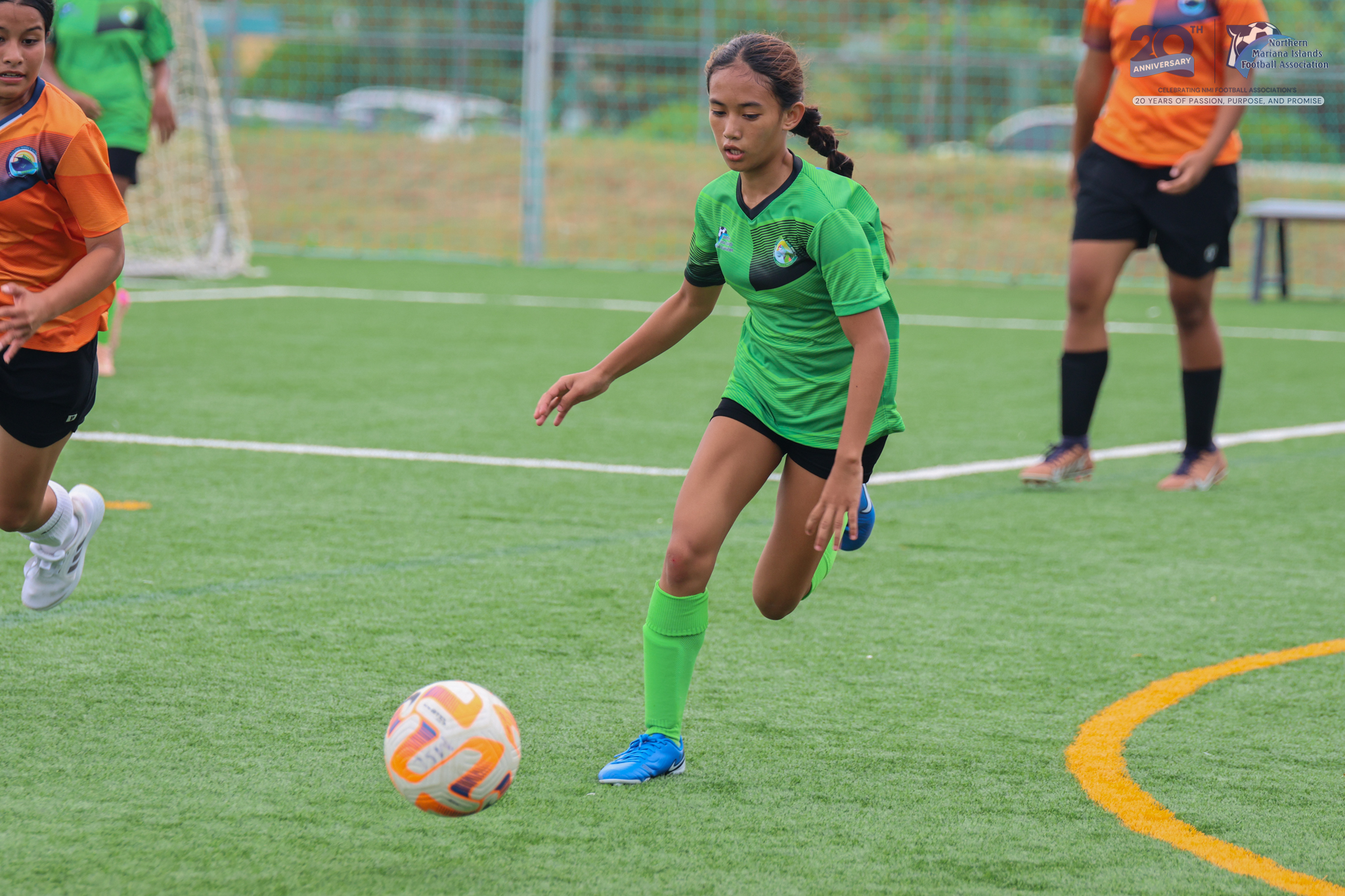 May be an image of 4 people, people playing soccer, people playing football, grass and text