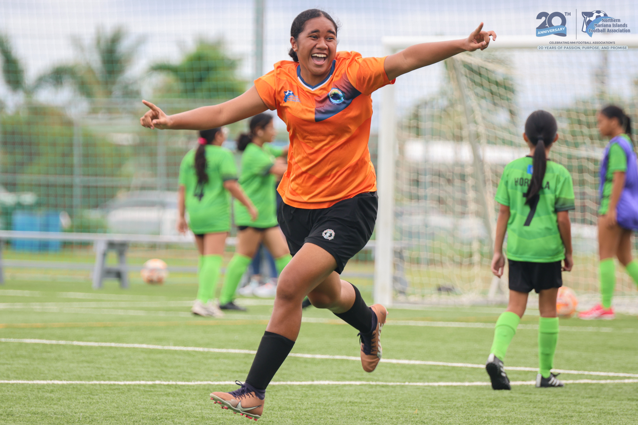 May be an image of 3 people, people playing soccer, people playing football, grass and text