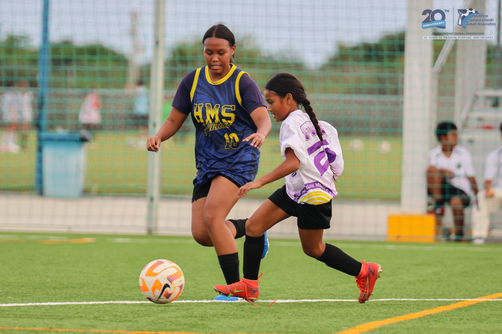 May be an image of 4 people, people playing football, people playing soccer, grass and text