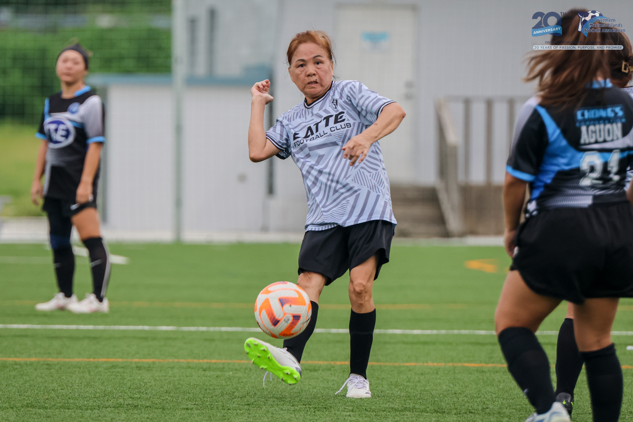 May be an image of 3 people, people playing soccer, people playing football, grass and text