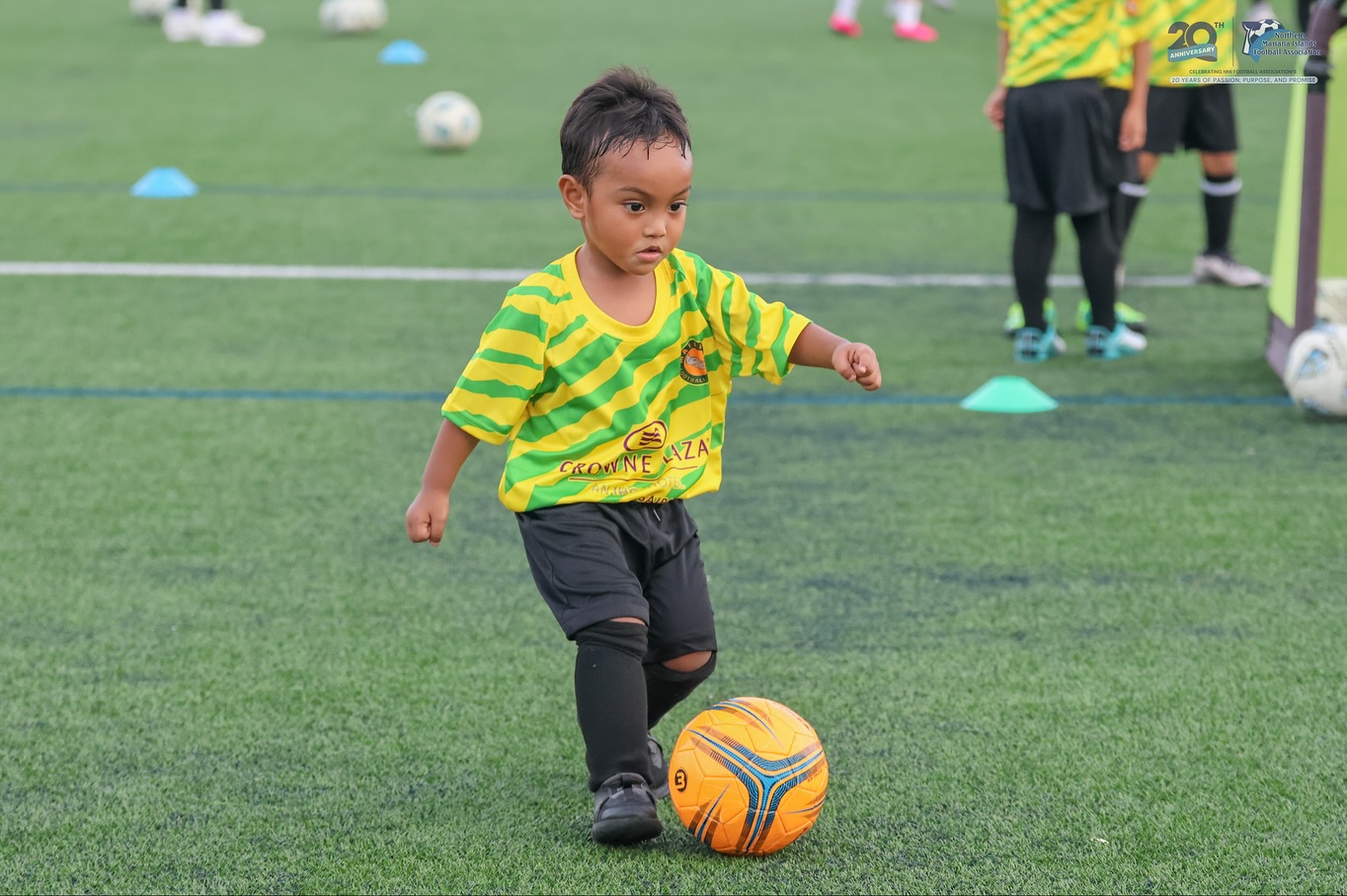 May be an image of 3 people, child, people playing soccer, people playing football and text