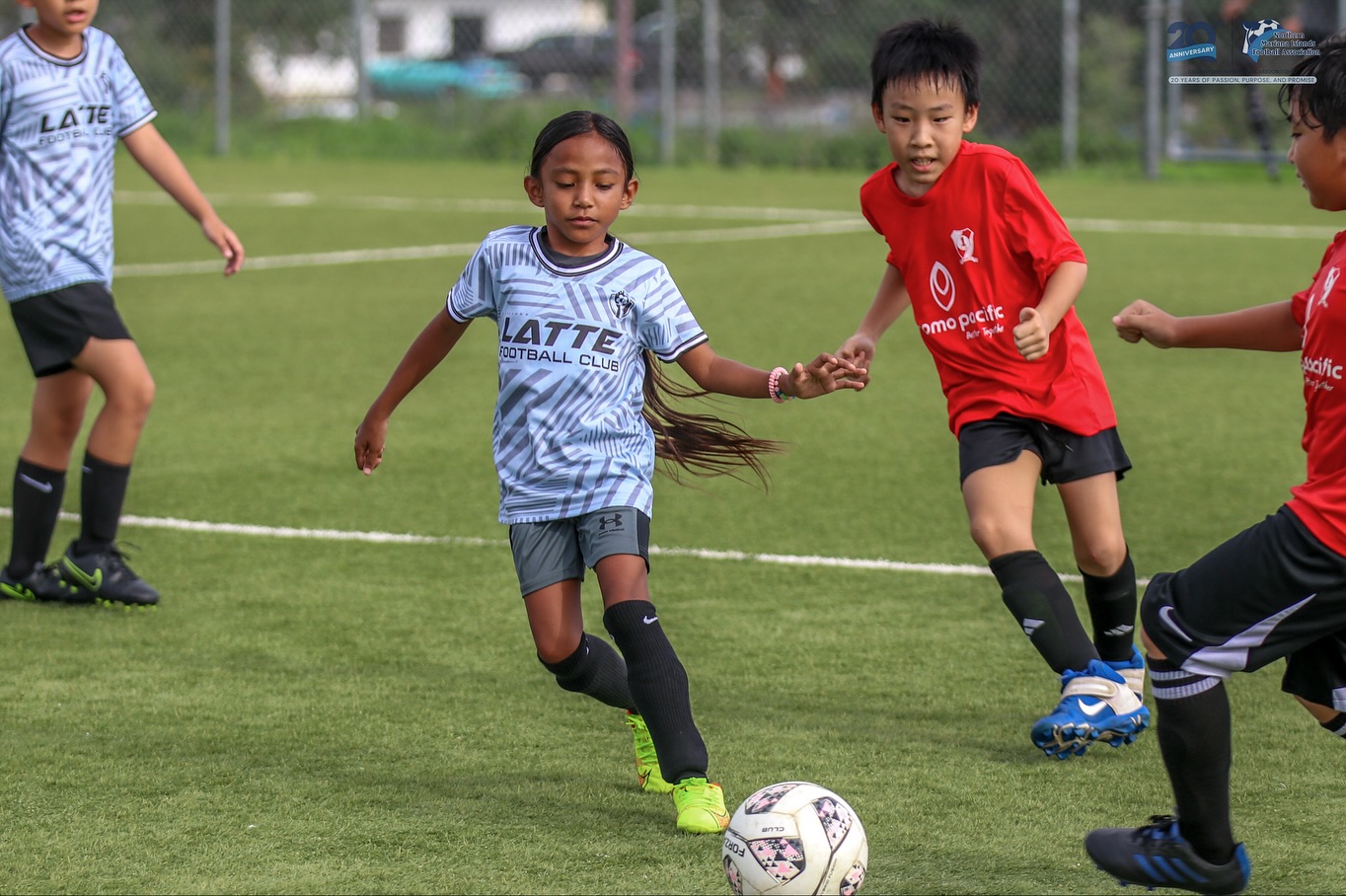 May be an image of 4 people, people playing football, people playing soccer and text