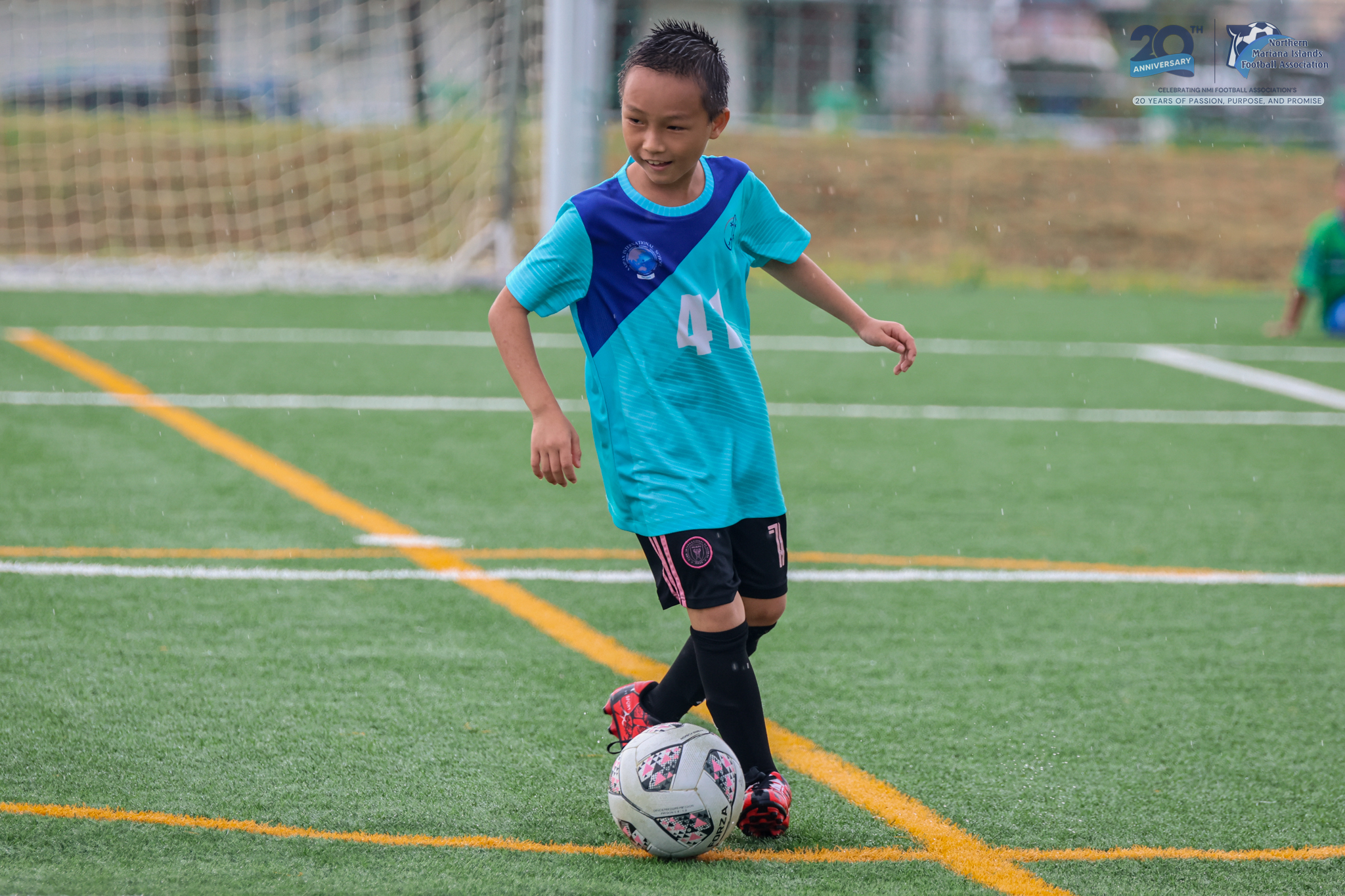 May be an image of 2 people, people playing football, people playing soccer, grass and text
