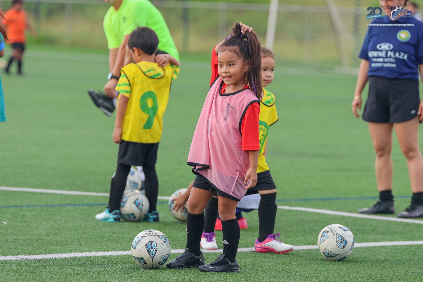 May be an image of 5 people, child, people playing football, people playing soccer and text