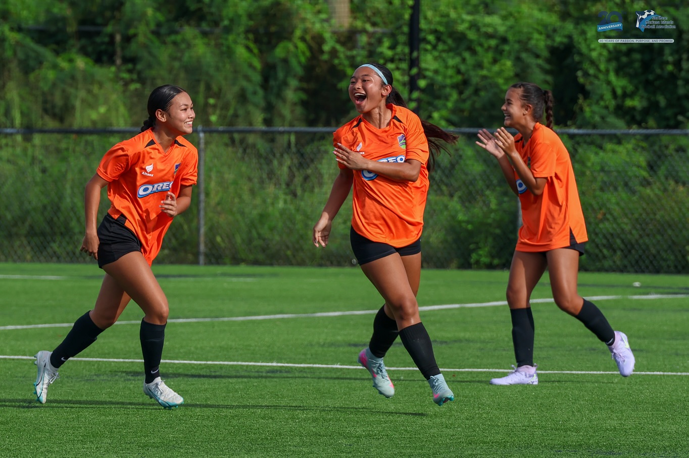 May be an image of 3 people, people playing football, people playing soccer and text