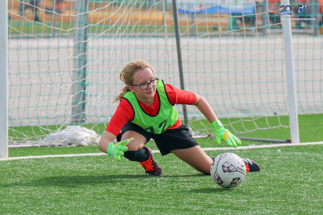 May be an image of 1 person, playing soccer, playing football and text