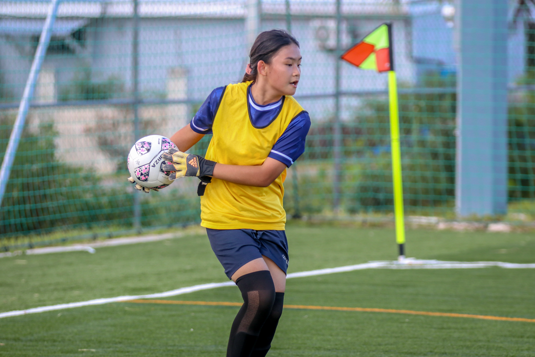 May be an image of 1 person, playing football, playing soccer, grass and text