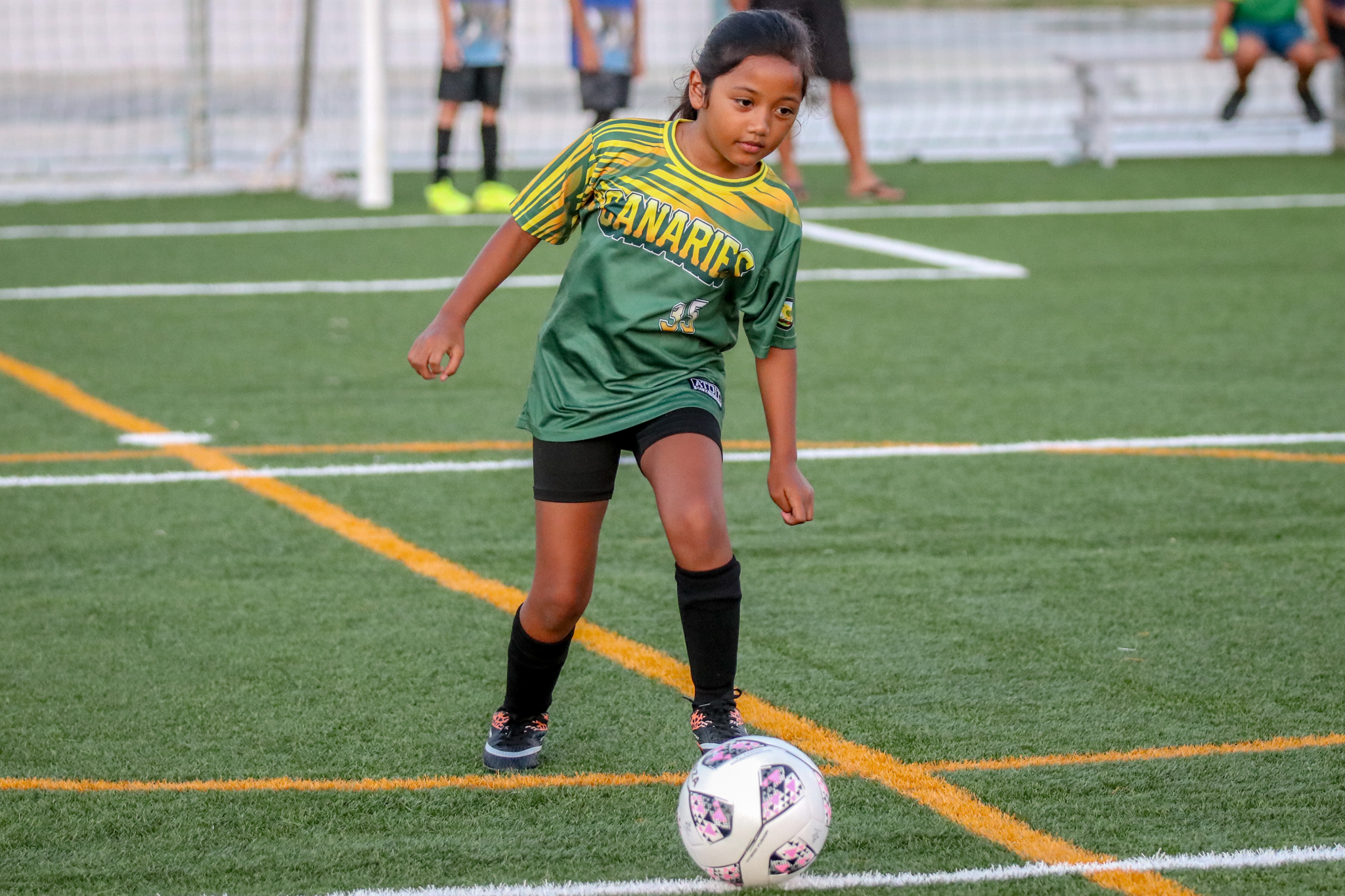 May be an image of 4 people, people playing football, people playing soccer, grass and text