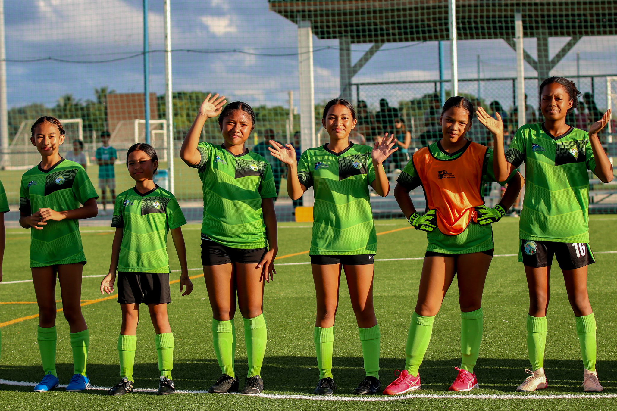 May be an image of 7 people, people playing football, people playing soccer, grass and text