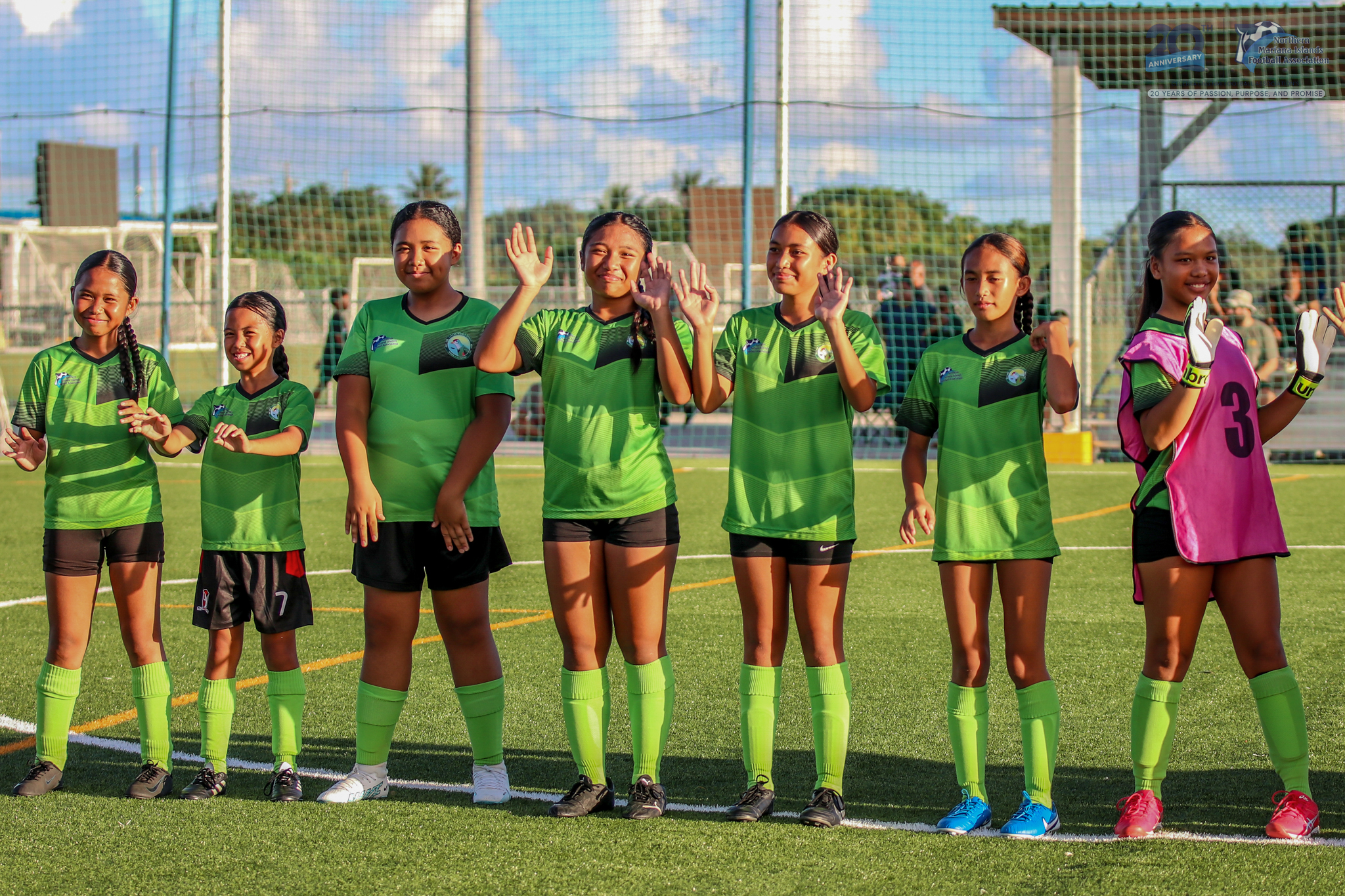 May be an image of 7 people, people playing soccer, people playing football, grass and text