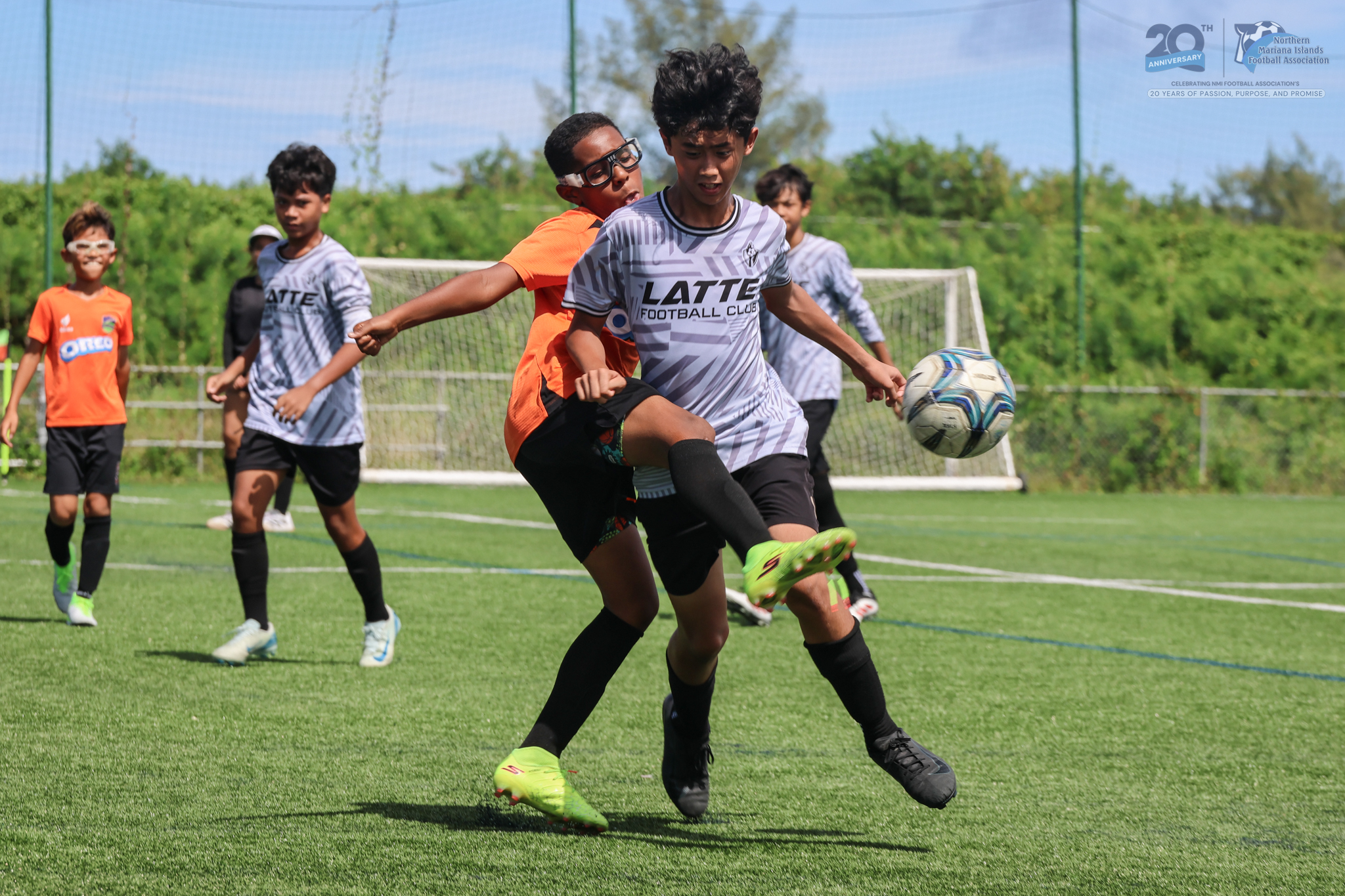 May be an image of 3 people, people playing football, people playing soccer and text
