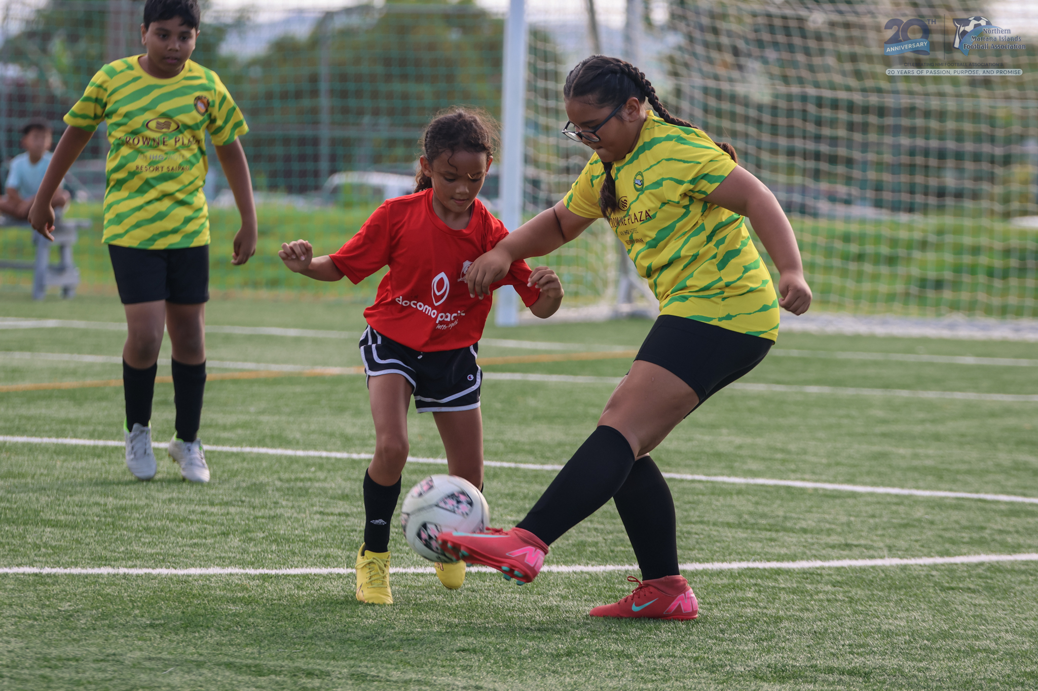 May be an image of 3 people, people playing football, people playing soccer and text