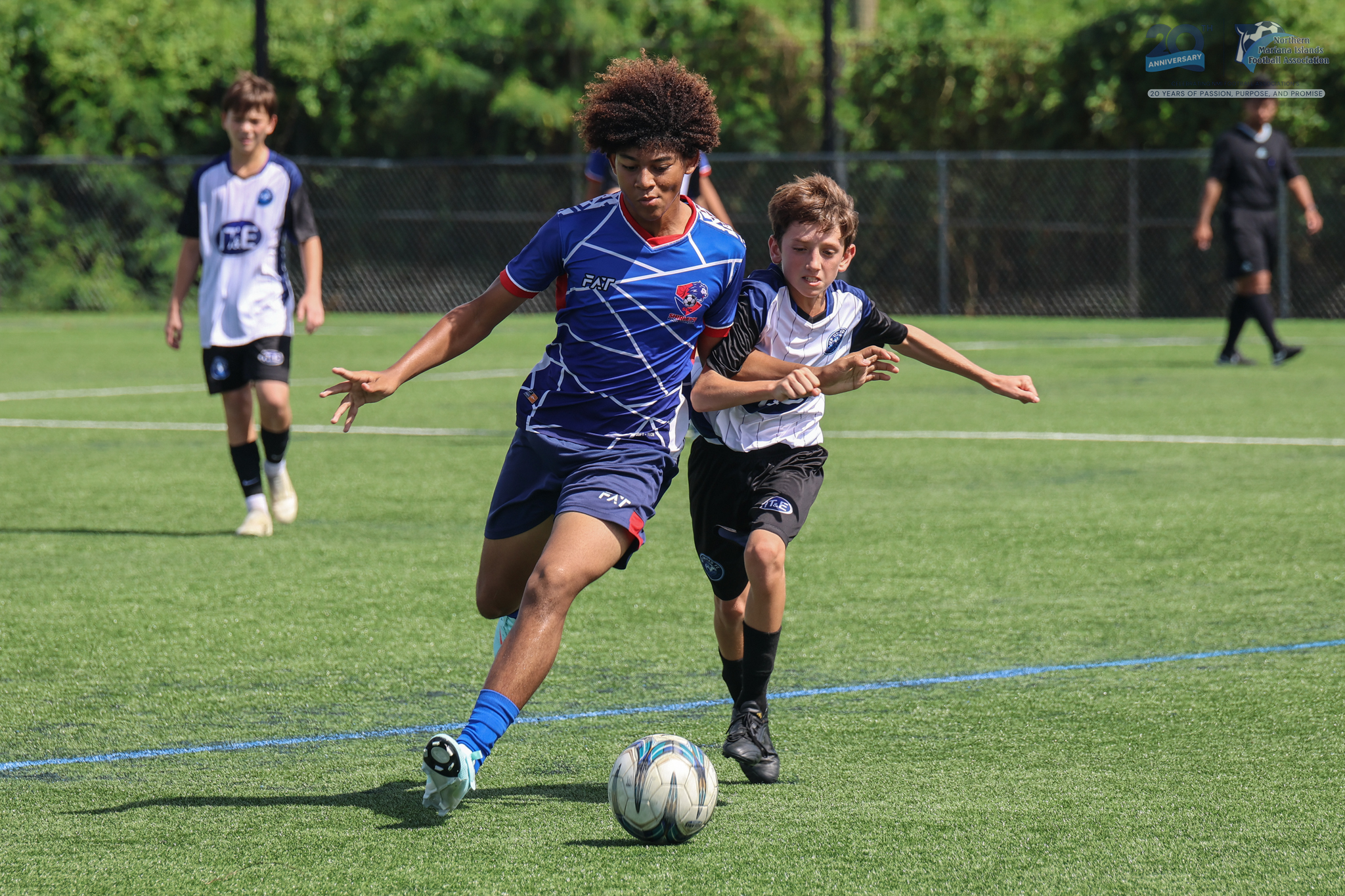 May be an image of 4 people, people playing football, people playing soccer, grass and text