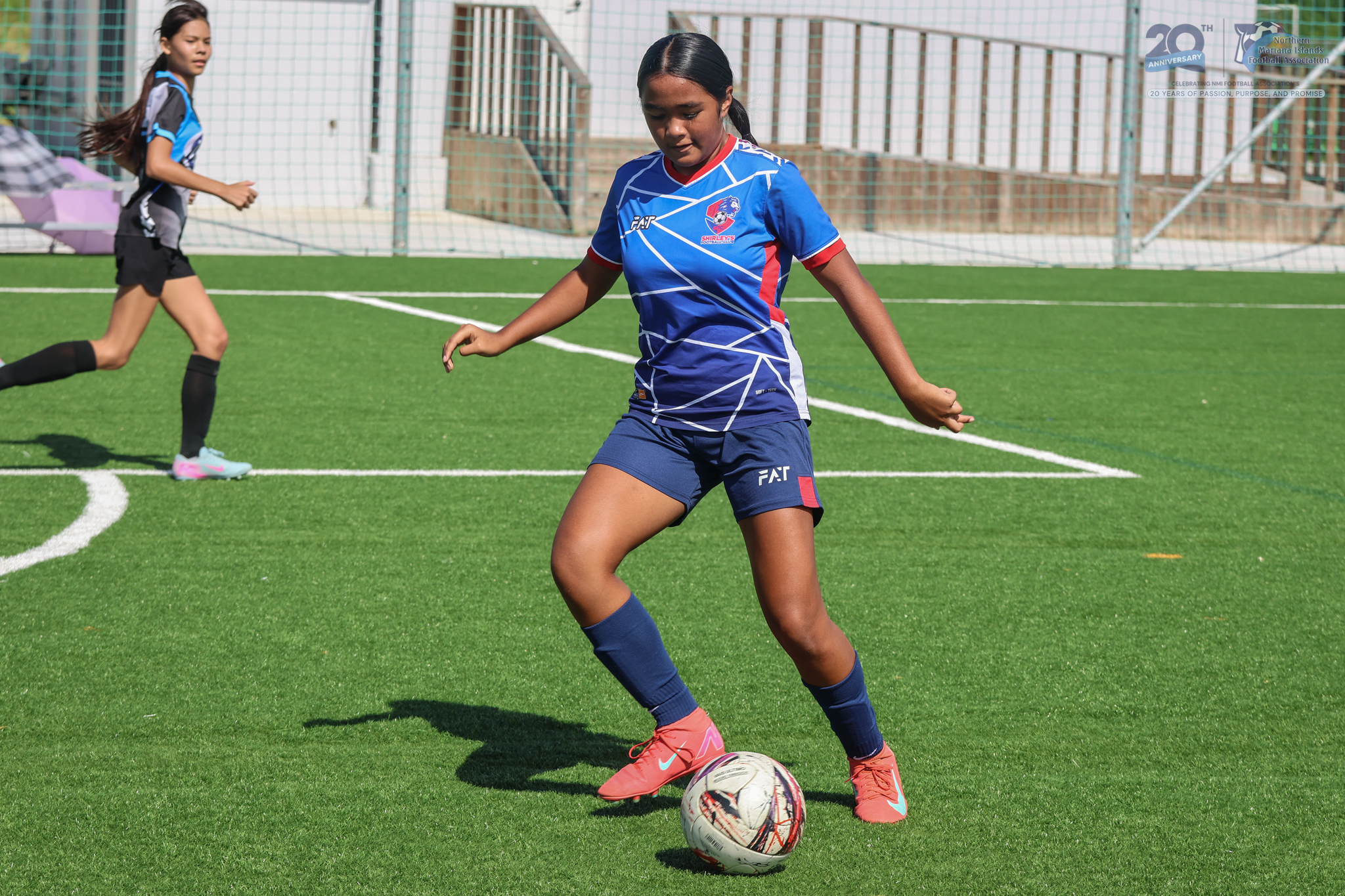 May be an image of 2 people, people playing football, people playing soccer, grass and text