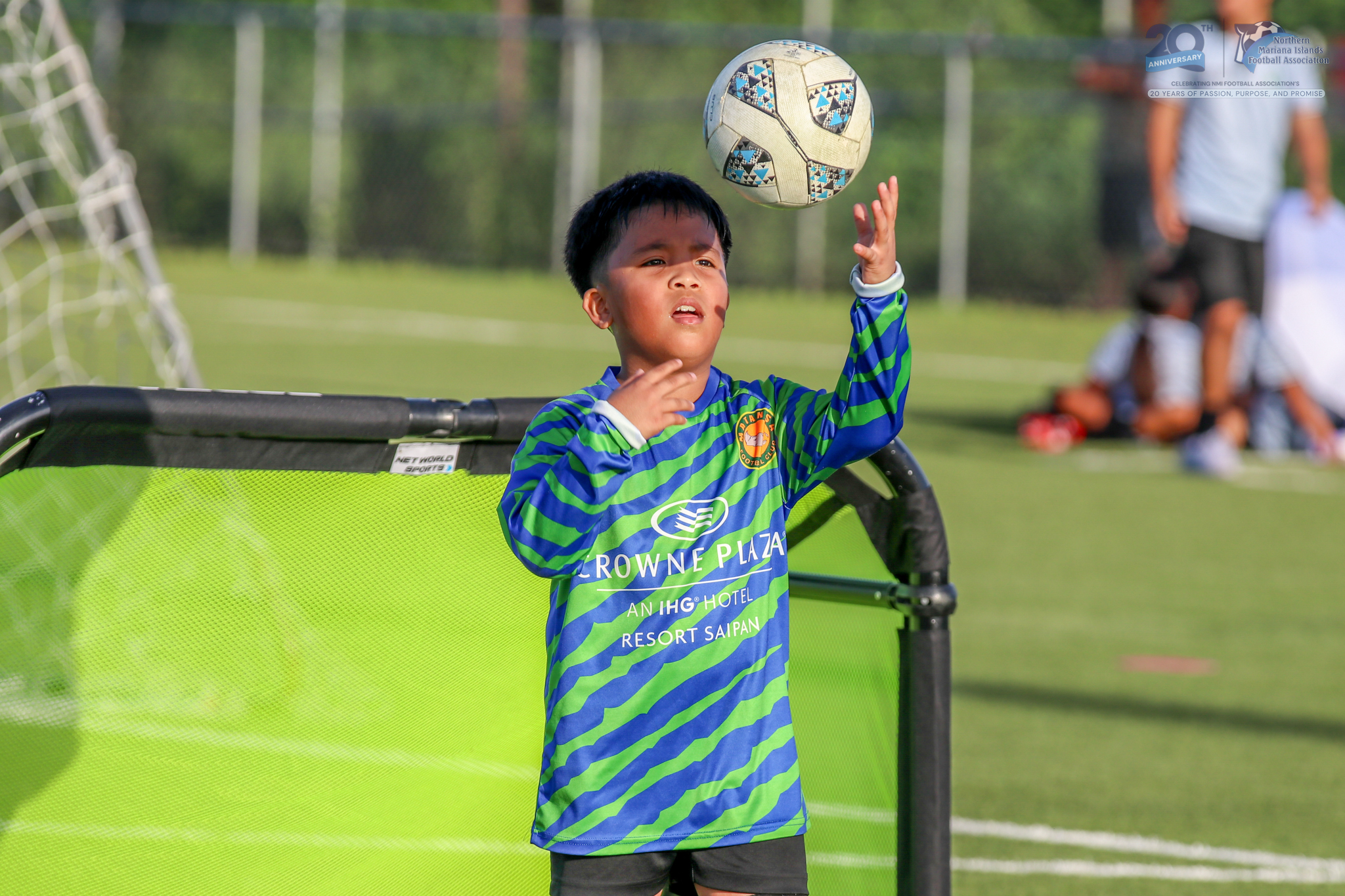 May be an image of child, football, soccer and text