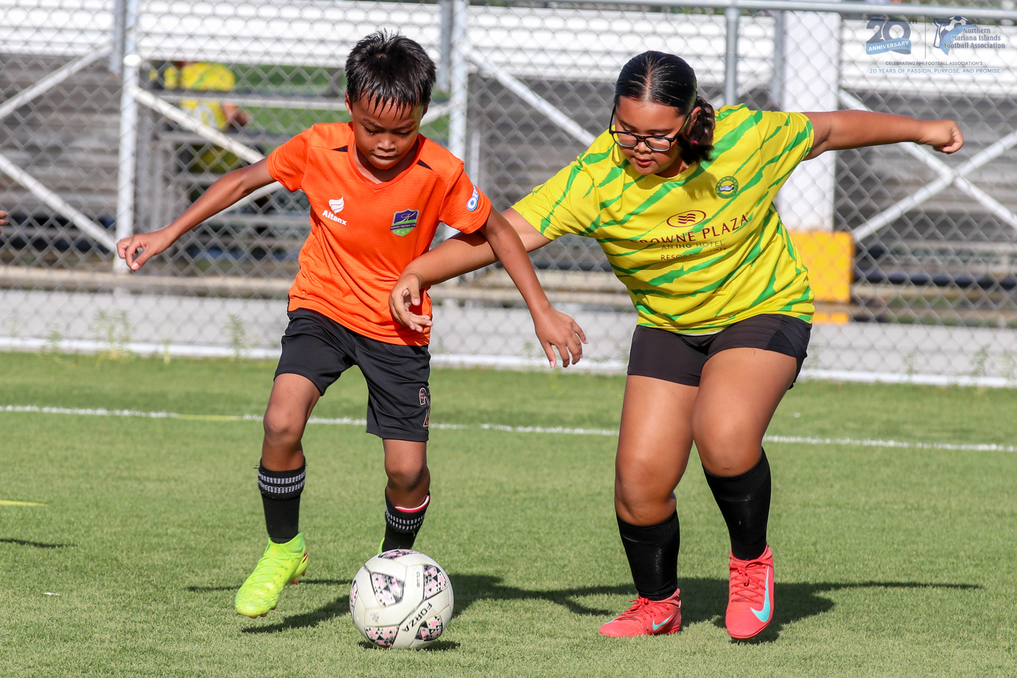 May be an image of football, soccer, grass and text