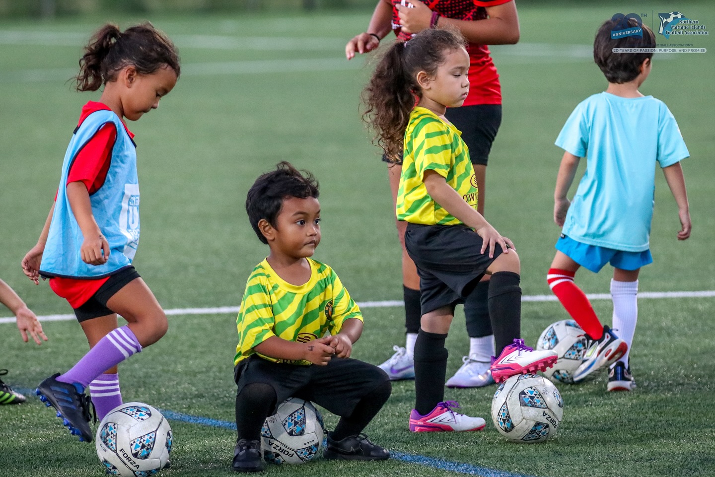 May be an image of child, football and soccer